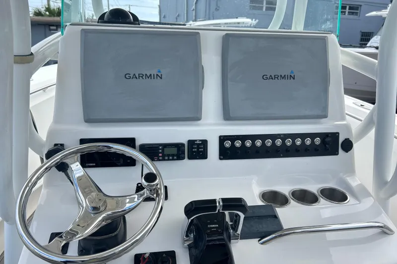 Slide: The Image of 2015 Cape Horn 32 XS boat dashboard with dual Garmin displays and Yamaha controls. - 12