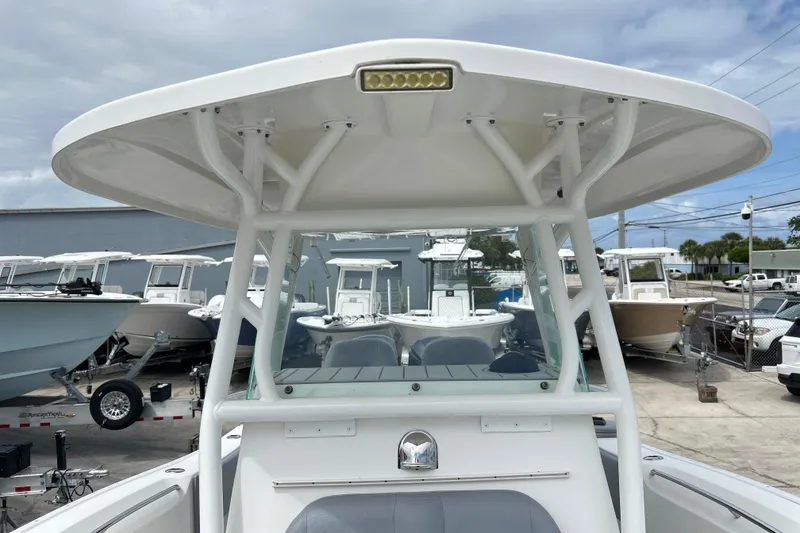 Slide: The Image of 2015 Cape Horn 32 XS boat with T-top, docked among other boats. - 14