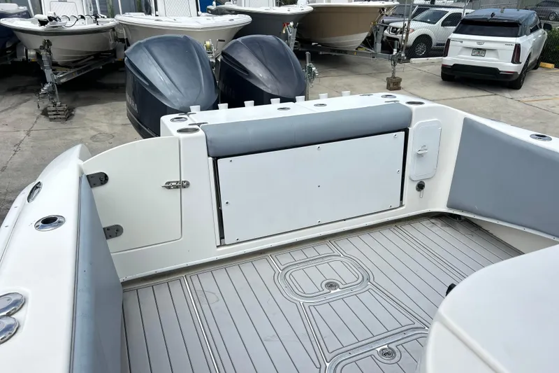 Slide: The Image of 2015 Cape Horn 32 XS boat interior with dual outboard motors in a marina. - 2