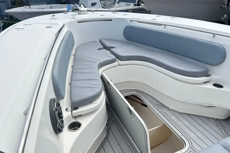 Slide: The Image of 2015 Cape Horn 32 XS boat interior with cushioned seating and storage compartment. - 22
