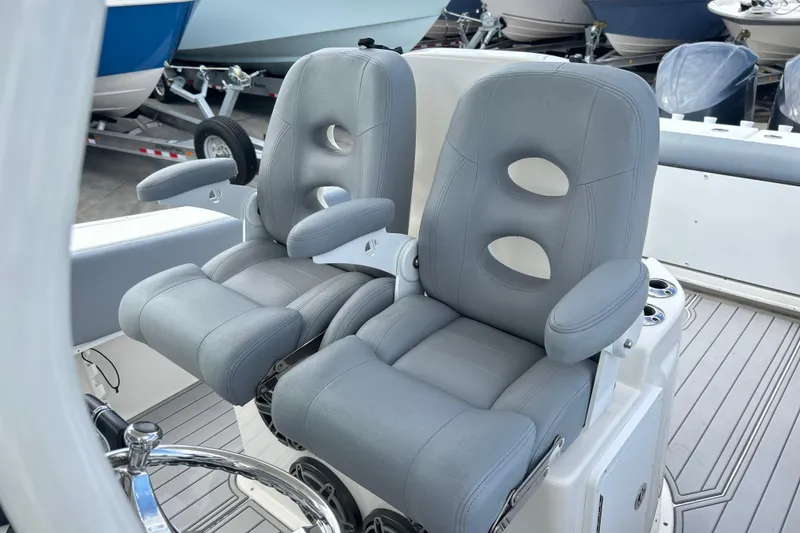 Slide: The Image of 2015 Cape Horn 32 XS boat with dual gray captain seats and steering wheel. - 26