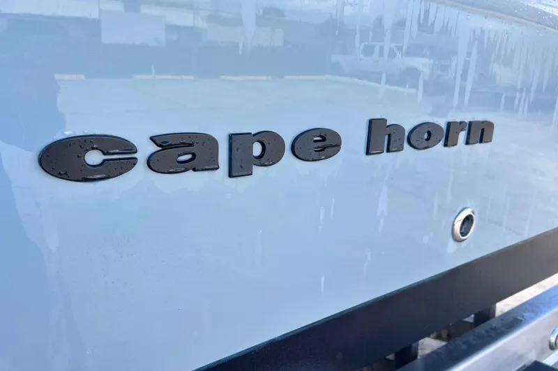 Slide: The Image of Close-up of 2015 Cape Horn 32 XS boat logo with water droplets. - 34
