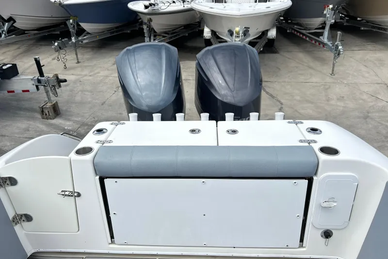 Slide: The Image of 2015 Cape Horn 32 XS boat with dual engines, docked among other boats. - 4
