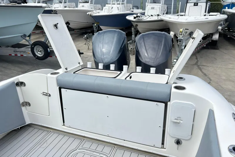Slide: The Image of 2015 Cape Horn 32 XS boat with dual outboard motors and open storage compartments. - 5