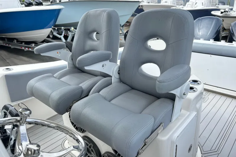 Slide: The Image of 2015 Cape Horn 32 XS boat cockpit with dual gray captain chairs. - 8
