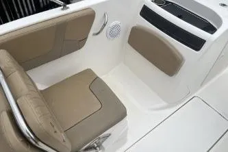 Slide: The Image of 2022 Bayliner VR6 Bowrider OB interior with tan seating and modern design. - 10