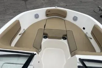 Slide: The Image of 2022 Bayliner VR6 Bowrider OB interior with beige seating and cup holders. - 11