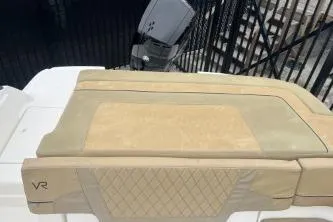 Slide: The Image of 2022 Bayliner VR6 Bowrider OB boat with beige seating and outboard motor. - 12