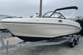 Slide: The Image of 2022 Bayliner VR6 Bowrider OB on trailer, sleek design, white exterior, black canopy. - 4