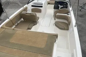 Slide: The Image of 2022 Bayliner VR6 Bowrider OB interior with beige seating and steering console. - 7
