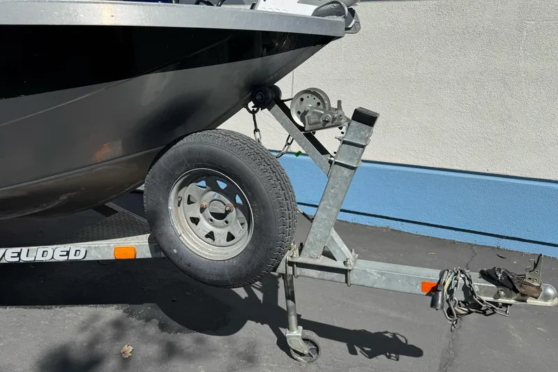 Slide: The Image of Trailer hitch and wheel of a 2008 Jetcraft 1925 Adventurer boat on pavement. - 10