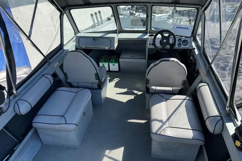 Slide: The Image of Interior of 2008 Jetcraft 1925 Adventurer boat with seating and steering console. - 14