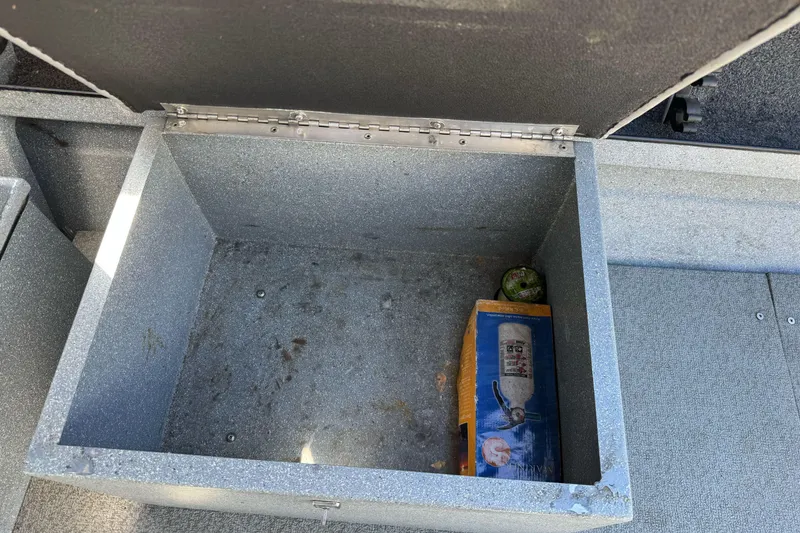 Slide: The Image of Open storage compartment in a 2008 Jetcraft 1925 Adventurer boat, containing a fire extinguisher. - 18