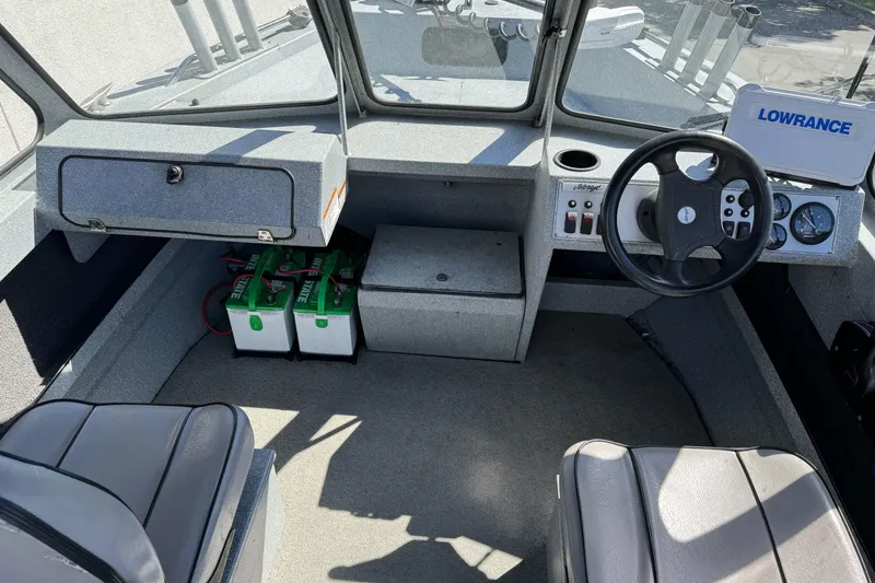 Slide: The Image of Interior of a 2008 Jetcraft 1925 Adventurer boat with steering wheel and control panel. - 19