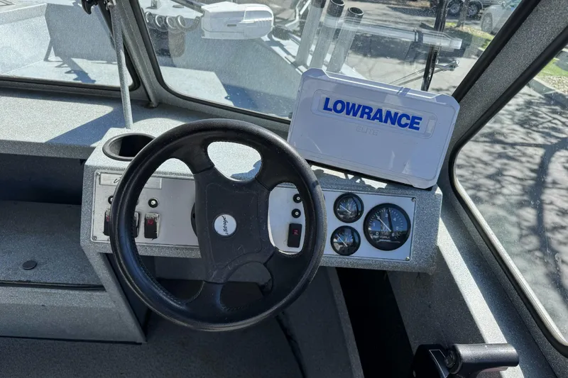 Slide: The Image of Interior of a 2008 Jetcraft 1925 Adventurer boat with steering wheel and Lowrance device. - 20
