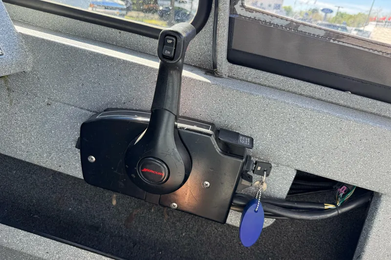 Slide: The Image of Throttle control of 2008 Jetcraft 1925 Adventurer boat with key and blue tag. - 22