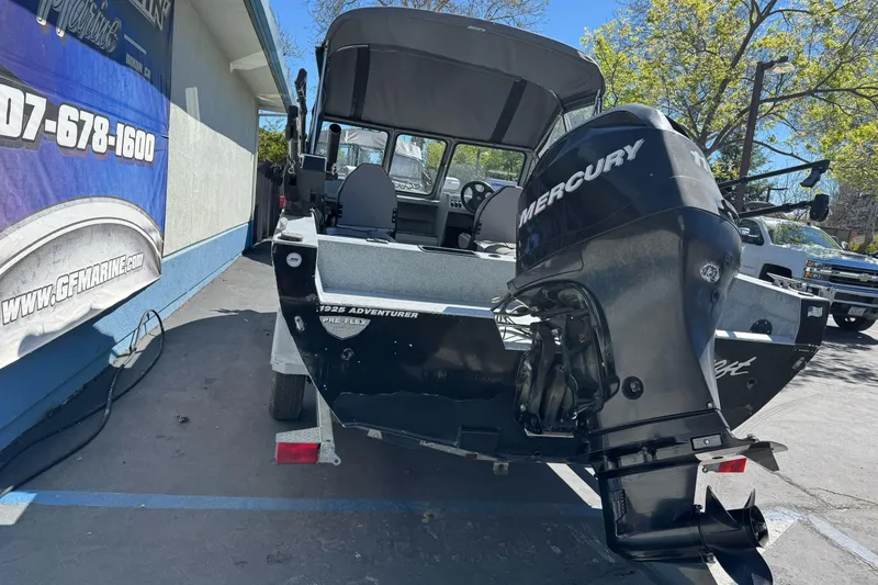 Slide: The Image of Jetcraft 1925 Adventurer boat with Mercury outboard motor, parked outdoors, 2008 model. - 4