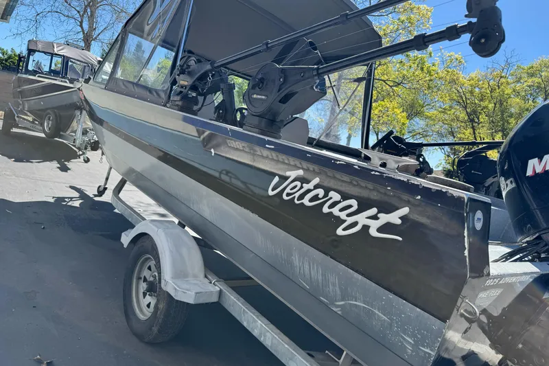 Slide: The Image of 2008 Jetcraft 1925 Adventurer boat on trailer, parked outdoors under clear sky. - 5