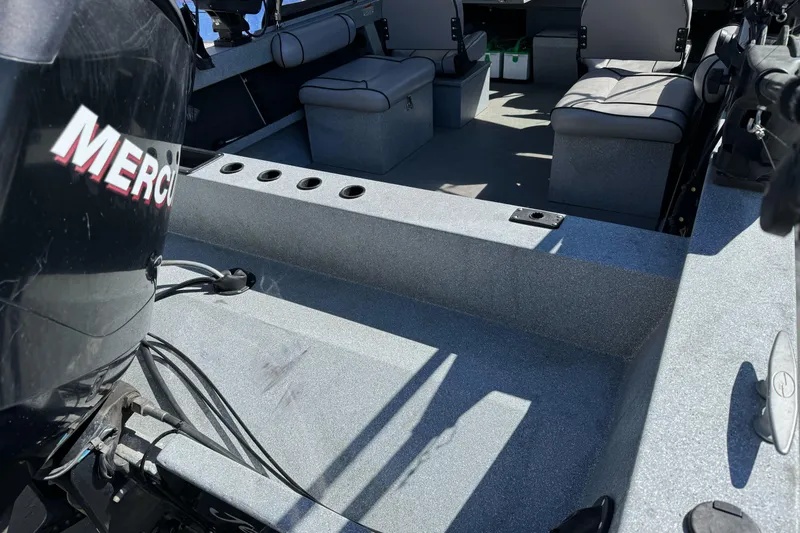 Slide: The Image of Interior of a 2008 Jetcraft 1925 Adventurer boat with seating and Mercury engine. - 7