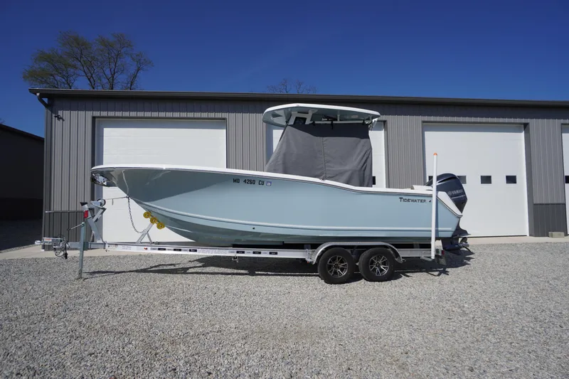 The Image of 2024 Tidewater 232 LXF boat on trailer, parked outside a garage. - 0