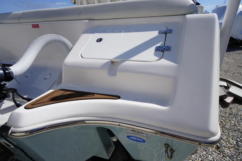 Slide: The Image of 2024 Tidewater 232 LXF boat detail, featuring sleek design and storage compartment. - 10