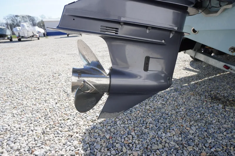 Slide: The Image of 2024 Tidewater 232 LXF boat propeller on gravel surface, showcasing sleek design. - 12