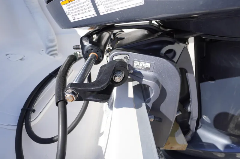 Slide: The Image of Close-up of 2024 Tidewater 232 LXF boat engine components and hydraulic system. - 13