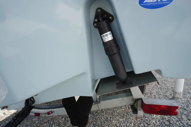 Slide: The Image of Close-up of 2024 Tidewater 232 LXF boat's trim tab mechanism on trailer. - 14