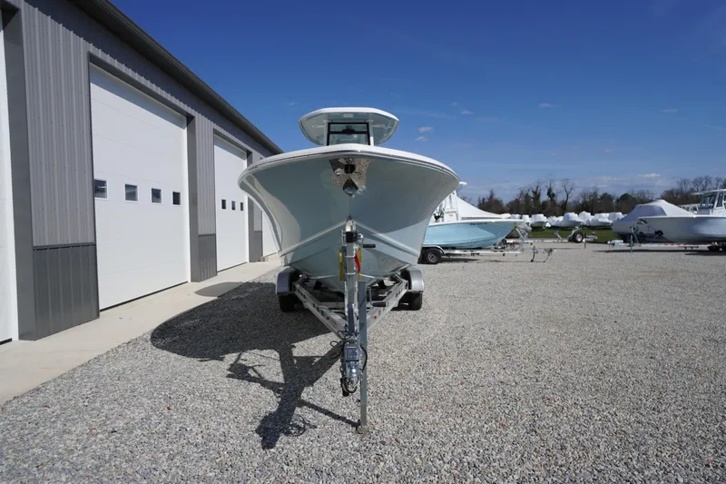 Slide: The Image of 2024 Tidewater 232 LXF boat on trailer, parked outside a storage facility. - 16