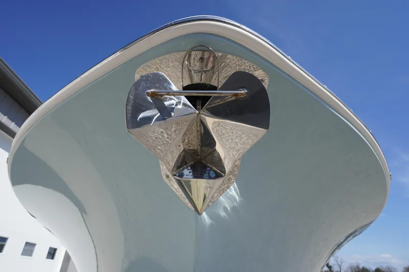 Slide: The Image of 2024 Tidewater 232 LXF boat bow with shiny anchor against blue sky. - 17