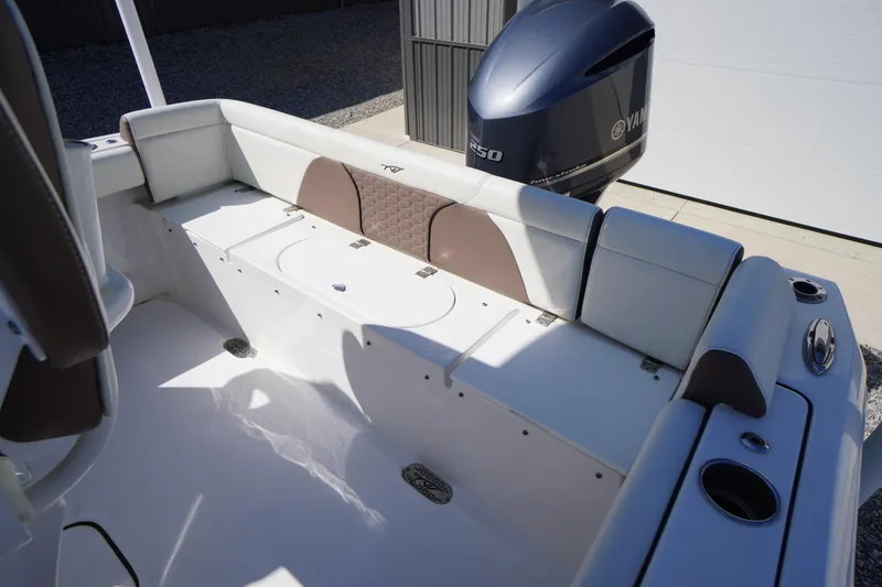 Slide: The Image of 2024 Tidewater 232 LXF boat interior with Yamaha engine, featuring cushioned seating and cup holders. - 22