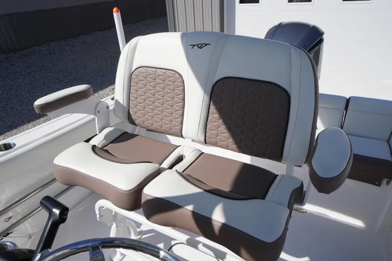 Slide: The Image of 2024 Tidewater 232 LXF boat seating with cushioned armrests and stylish upholstery design. - 24