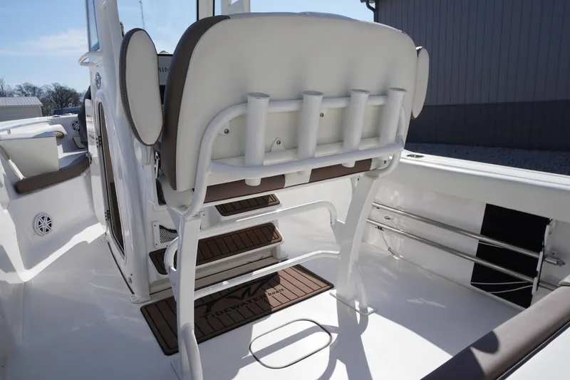 Slide: The Image of 2024 Tidewater 232 LXF boat interior with rod holders and cushioned seating. - 26