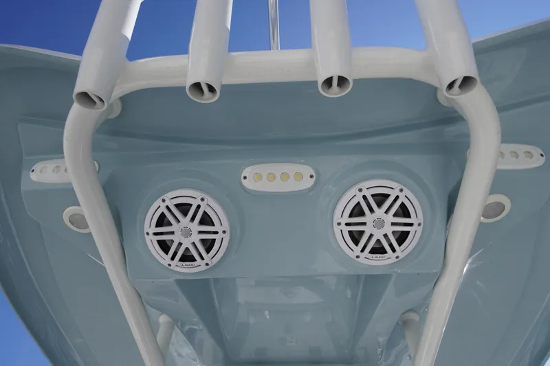 Slide: The Image of 2024 Tidewater 232 LXF boat speakers and rod holders under blue sky. - 27