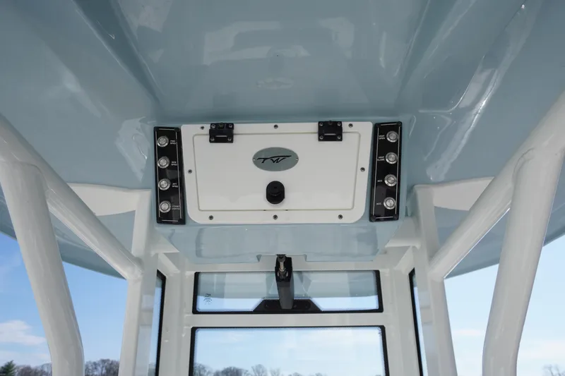 Slide: The Image of 2024 Tidewater 232 LXF boat console with control panel and storage compartment. - 28