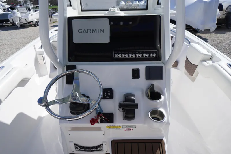 Slide: The Image of 2024 Tidewater 232 LXF boat console with Garmin display and steering wheel. - 31