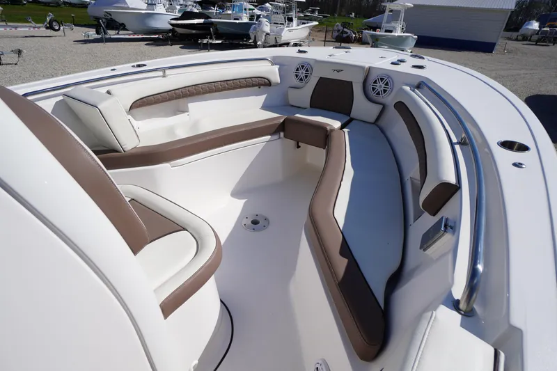 Slide: The Image of 2024 Tidewater 232 LXF boat interior with cushioned seating and modern design. - 35