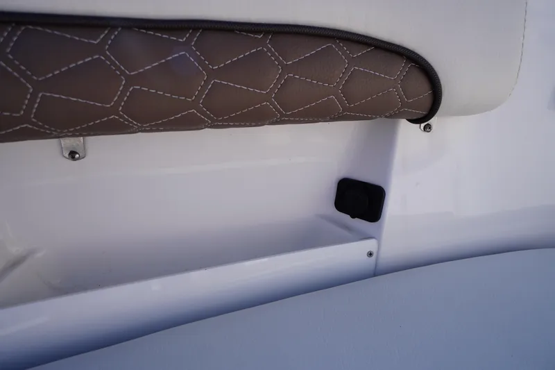 Slide: The Image of 2024 Tidewater 232 LXF boat interior detail with brown cushioned seating. - 41