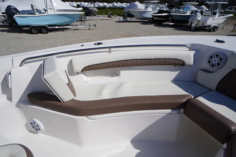 Slide: The Image of 2024 Tidewater 232 LXF boat interior with cushioned seating and speaker system. - 42