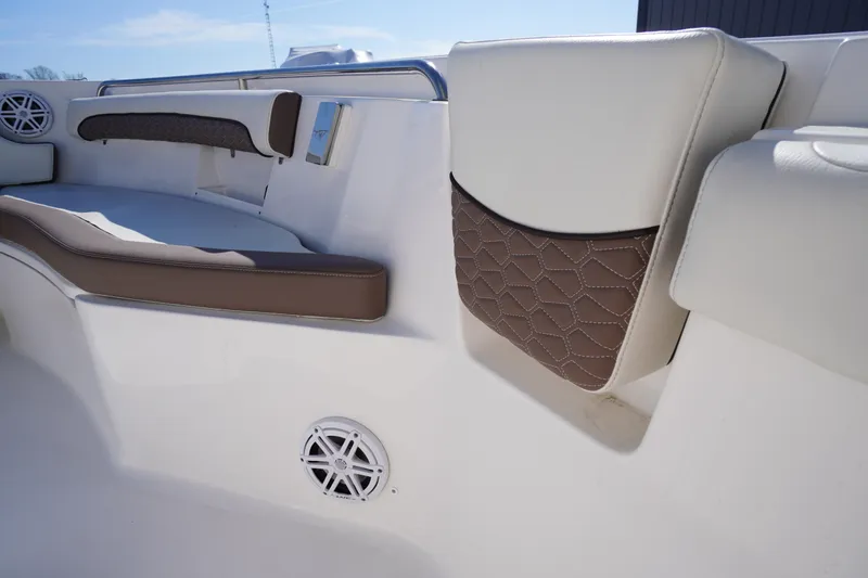 Slide: The Image of 2024 Tidewater 232 LXF boat interior with cushioned seating and speaker detail. - 44