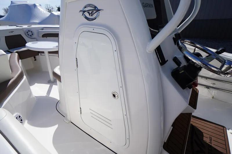 Slide: The Image of 2024 Tidewater 232 LXF boat interior with steering wheel and seating area. - 47