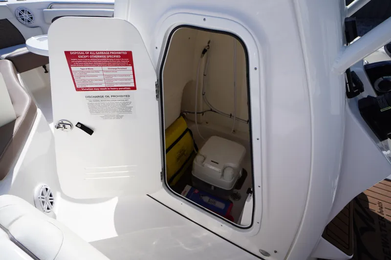 Slide: The Image of 2024 Tidewater 232 LXF boat interior storage compartment with safety equipment. - 48