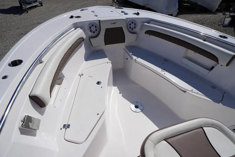Slide: The Image of 2024 Tidewater 232 LXF boat interior with cushioned seating and storage compartments. - 51