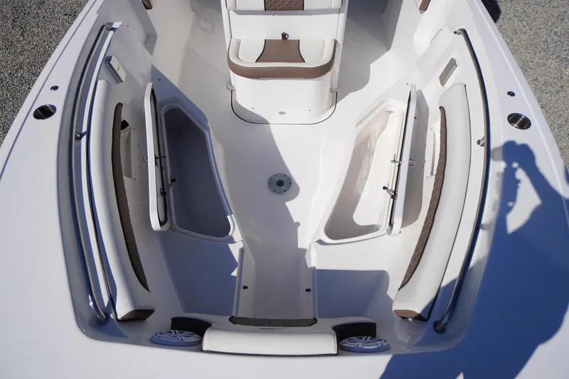 Slide: The Image of 2024 Tidewater 232 LXF boat interior with open storage compartments and seating. - 53