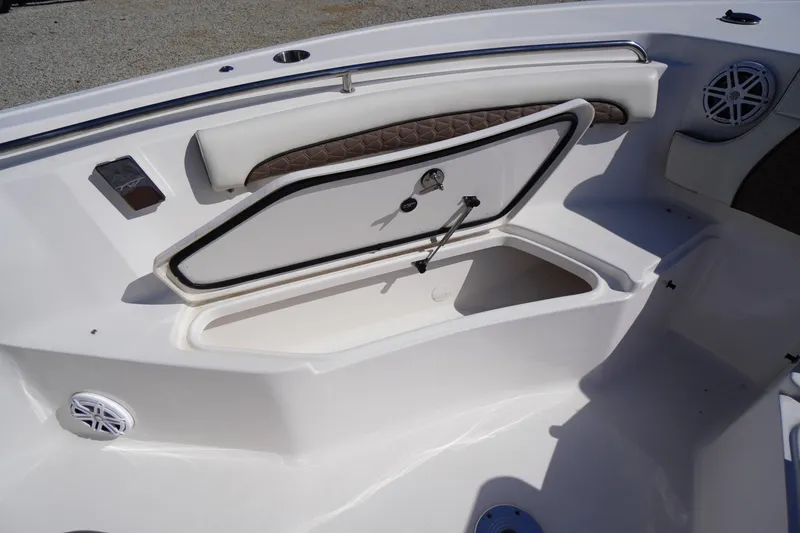Slide: The Image of 2024 Tidewater 232 LXF boat interior storage compartment with cushioned seating. - 55