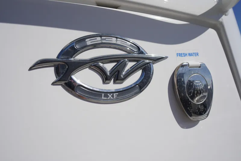 Slide: The Image of 2024 Tidewater 232 LXF boat emblem and fresh water access point. - 56