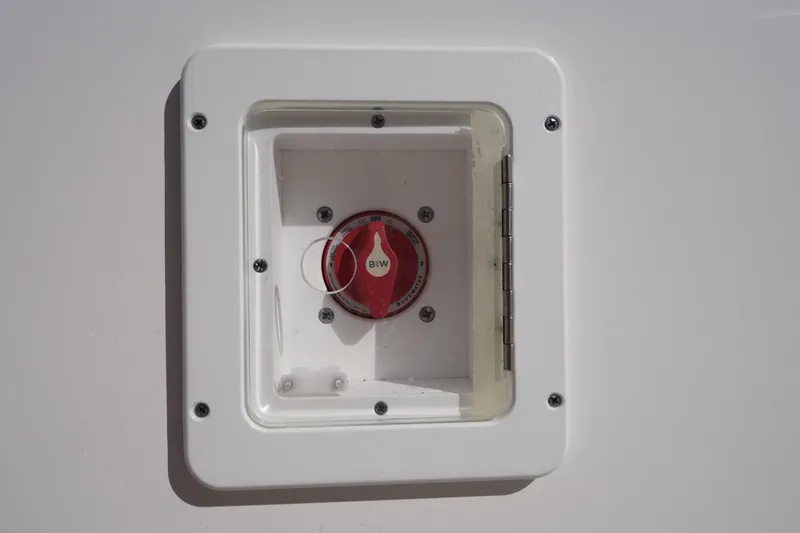 Slide: The Image of Battery switch on 2024 Tidewater 232 LXF boat, enclosed in a white panel. - 57