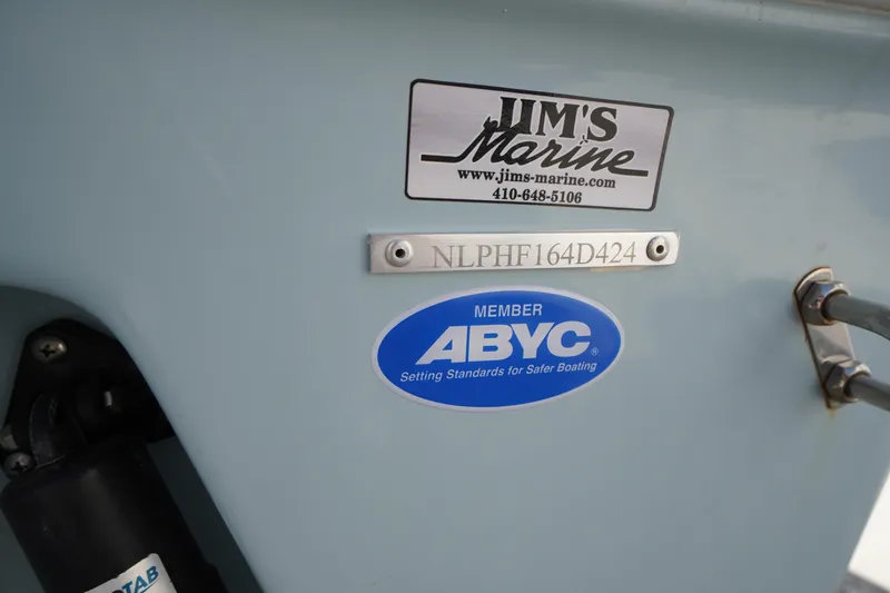 Slide: The Image of 2024 Tidewater 232 LXF boat with Jim's Marine and ABYC member stickers. - 59