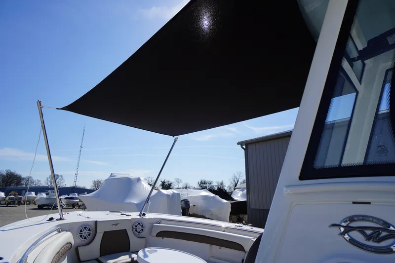 Slide: The Image of 2024 Tidewater 232 LXF boat with sunshade canopy and modern seating. - 60