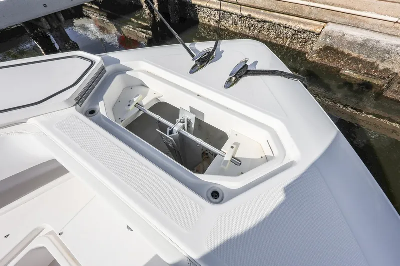 Slide: The Image of Anchor compartment of 2016 Invincible 39 Open Fisherman boat, docked by the water. - 10